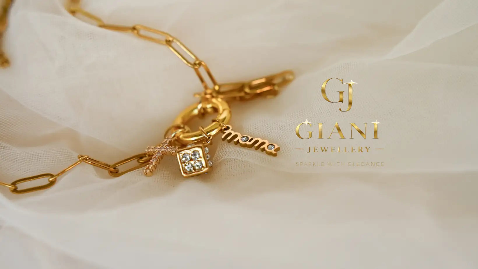 Gold-toned paperclip-style chain necklace featuring a ’mama’ charm and a square diamond-encrusted pendant.